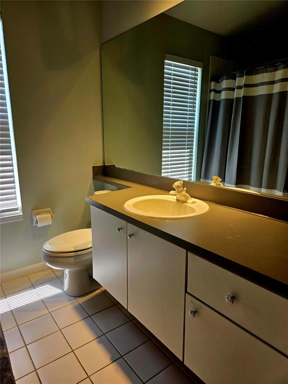 7838 Trail Run Loop New Port Richey, FL 34653 - Photo 28 of 36 a bathroom with a granite countertop sink and a toilet