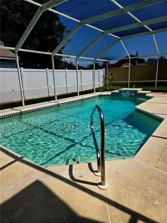 a view of swimming pool with outdoor seating and yard