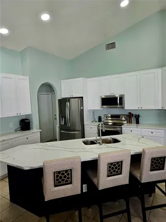 a kitchen with stainless steel appliances a stove a sink dishwasher and a refrigerator
