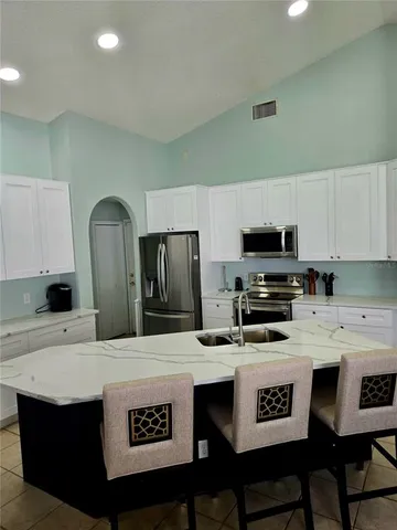 a kitchen with stainless steel appliances a stove a sink dishwasher and a refrigerator