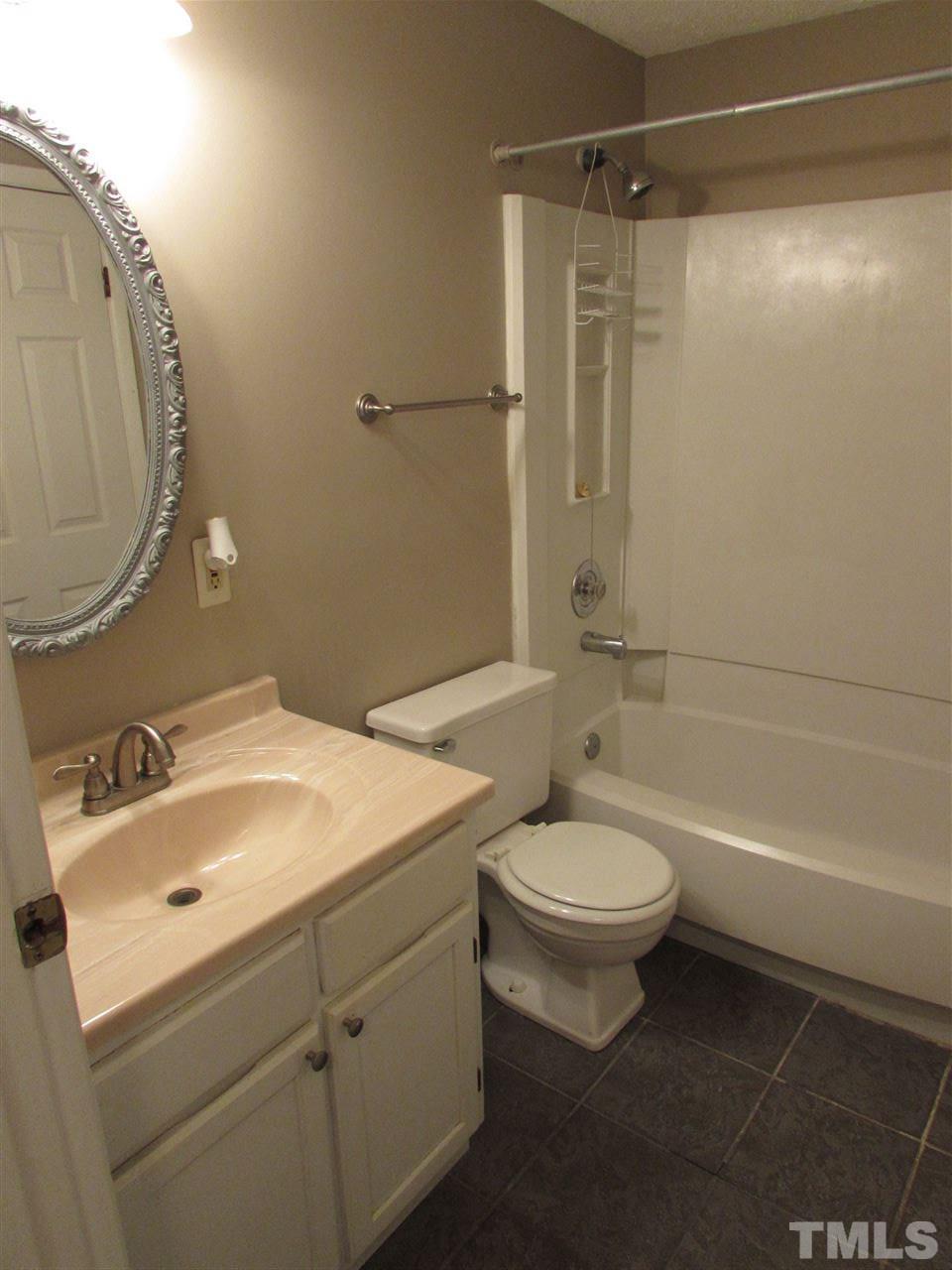 7750 Sandra Lane Raleigh, NC 27615 - Photo 13 of 25 a bathroom with a sink a toilet and shower