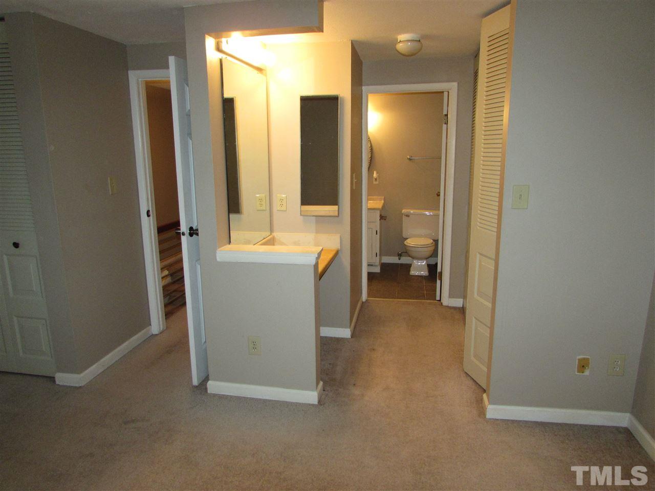7750 Sandra Lane Raleigh, NC 27615 - Photo 16 of 25 a view of a bathroom with a tub and a mirror
