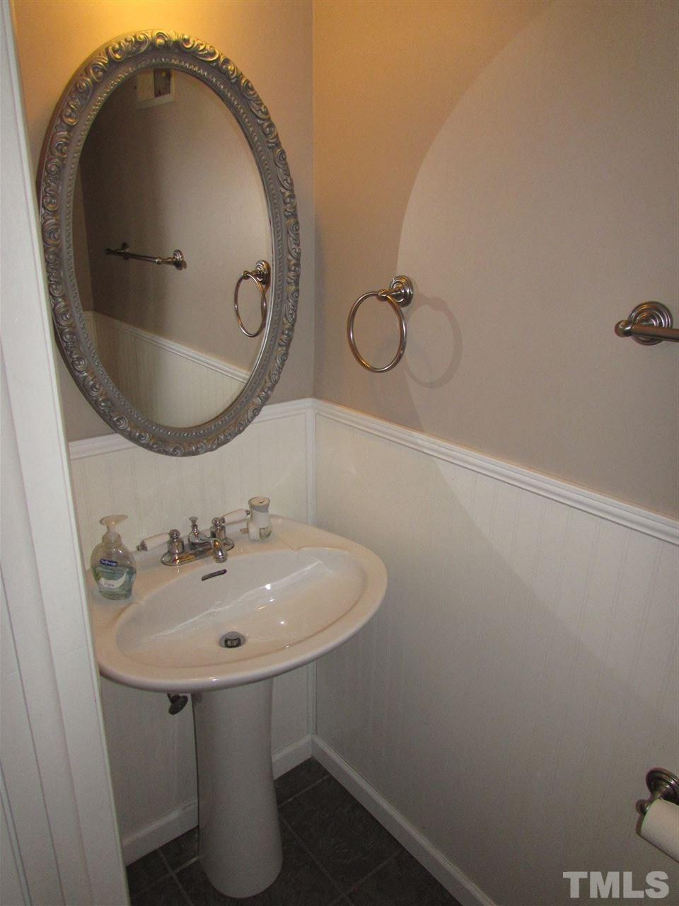 7750 Sandra Lane Raleigh, NC 27615 - Photo 19 of 25 a bathroom with a sink and mirror