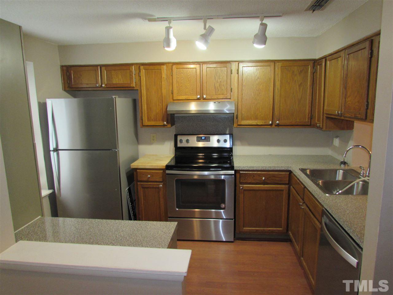 7750 Sandra Lane Raleigh, NC 27615 - Photo 3 of 25 a kitchen with a refrigerator stove and sink