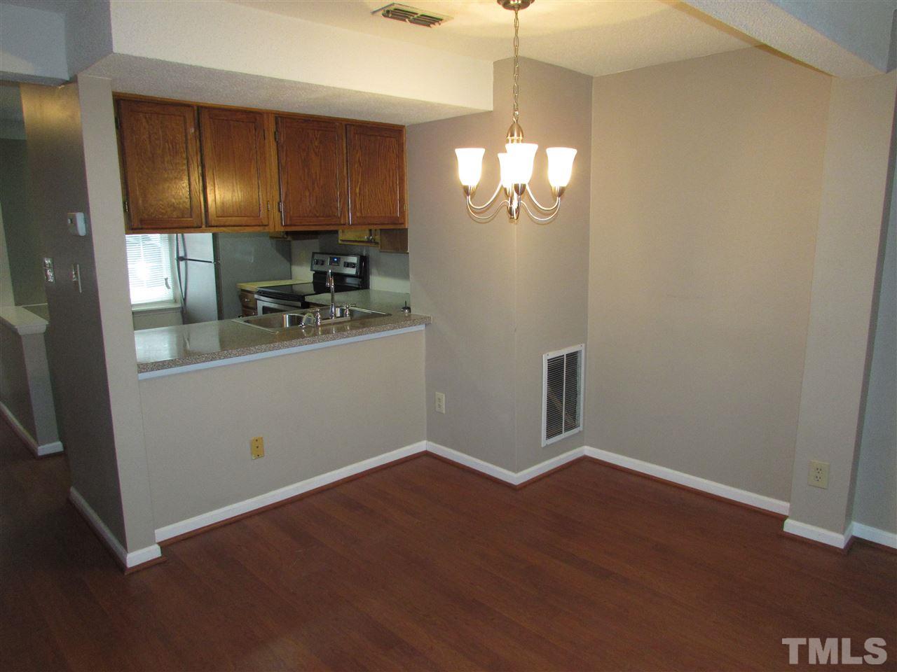 7750 Sandra Lane Raleigh, NC 27615 - Photo 6 of 25 a kitchen with granite countertop stainless steel appliances cabinets a sink and a counter top space