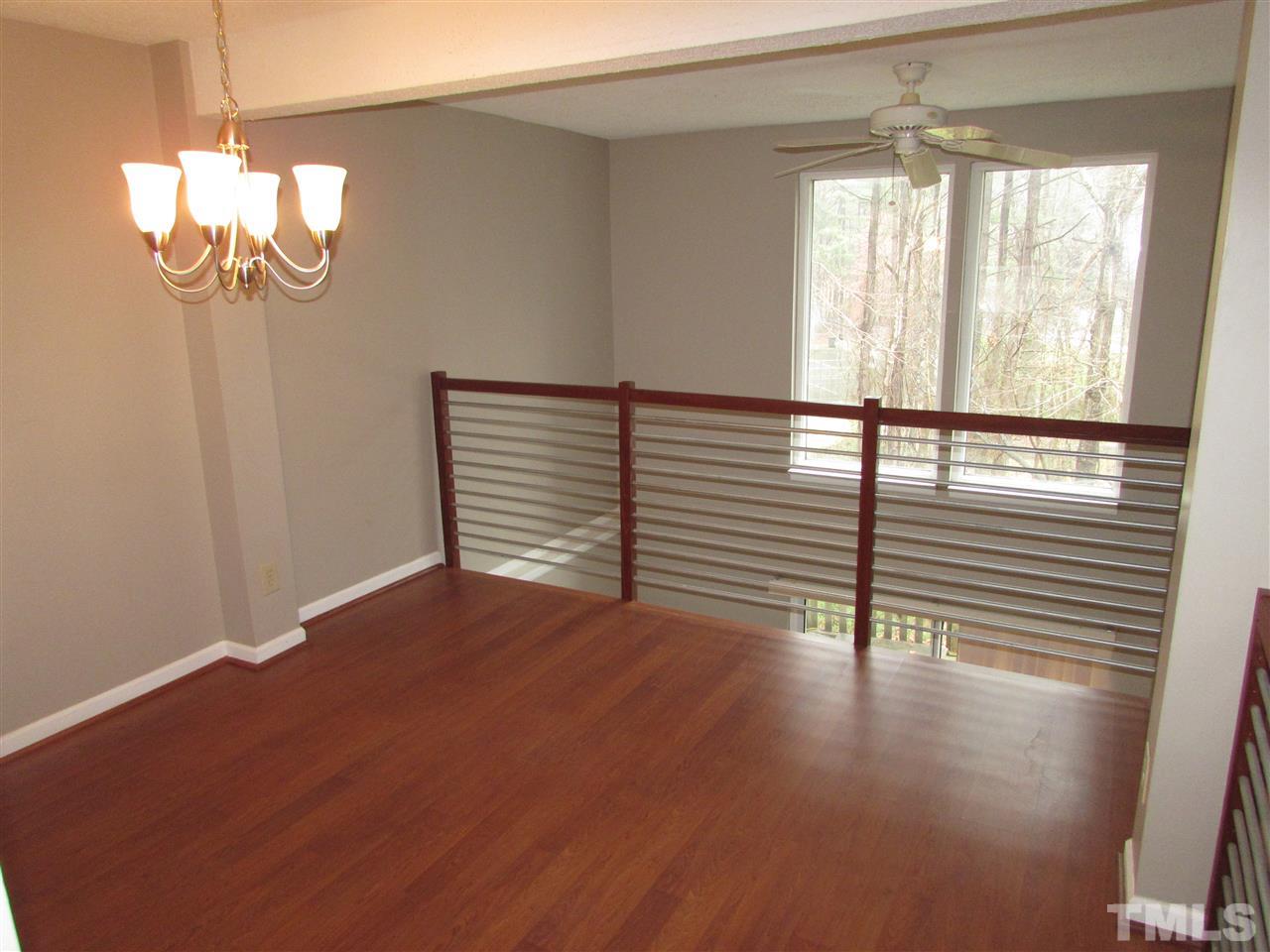 7750 Sandra Lane Raleigh, NC 27615 - Photo 7 of 25 a view of empty room with wooden floor and fan
