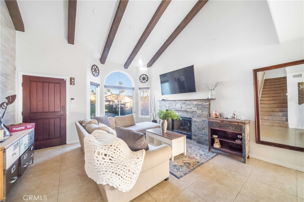 68845 Durango Road Cathedral City, CA 92234 - Photo 11 of 75 a living room with furniture a fireplace and a flat screen tv