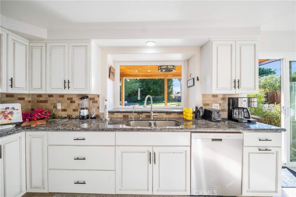 68845 Durango Road Cathedral City, CA 92234 - Photo 13 of 75 a kitchen with stainless steel appliances granite countertop a sink window and cabinets