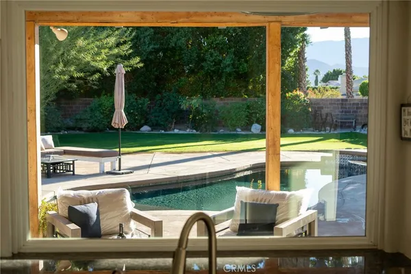 a kitchen with stainless steel appliances granite countertop a sink and a refrigerator