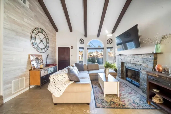 a living room with furniture a clock and a fireplace