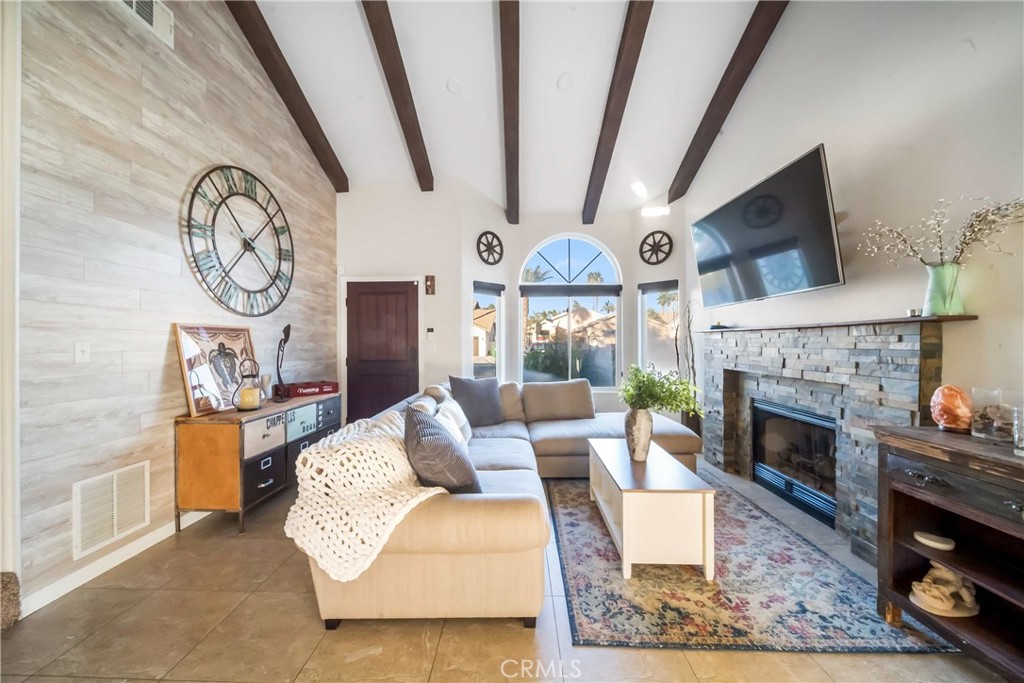 68845 Durango Road Cathedral City, CA 92234 - Photo 4 of 75 a living room with furniture a clock and a fireplace