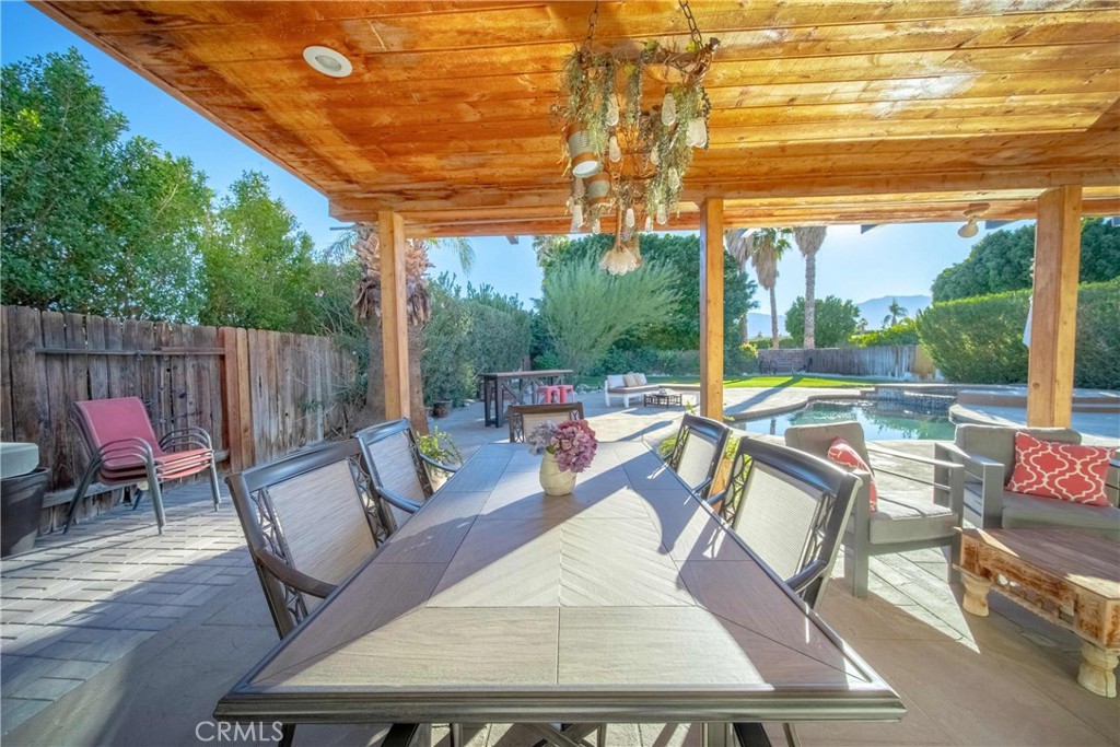68845 Durango Road Cathedral City, CA 92234 - Photo 68 of 75 a view of a patio with a dining table and chairs with wooden floor