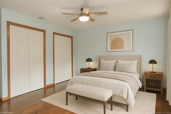 a bedroom with a bed and a chandelier