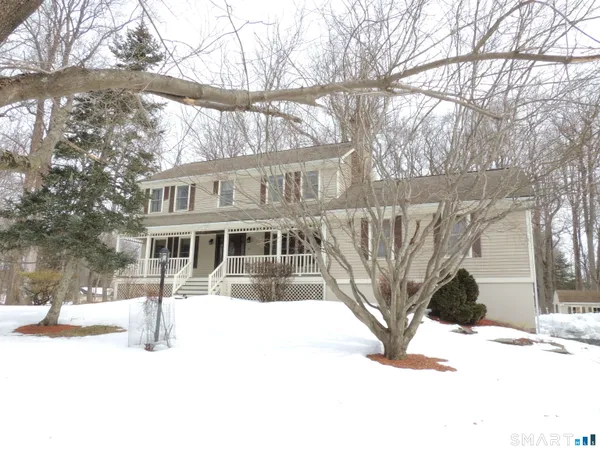 a view of a house with snow in the background