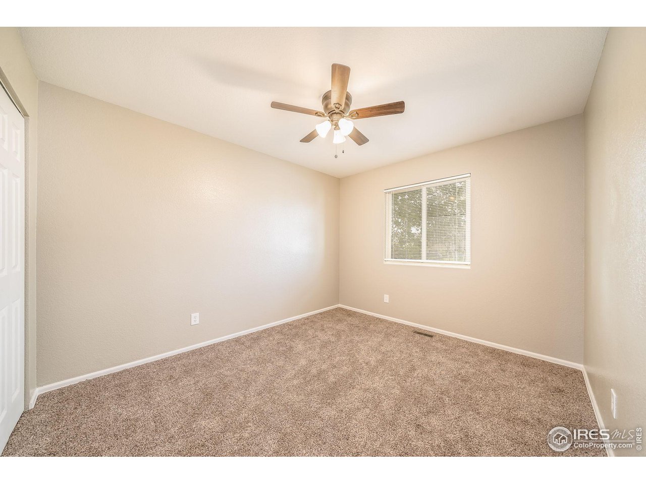 1021 East 25th St Road Greeley, CO 80631 - Photo 12 of 22 a view of an empty room with a ceiling fan