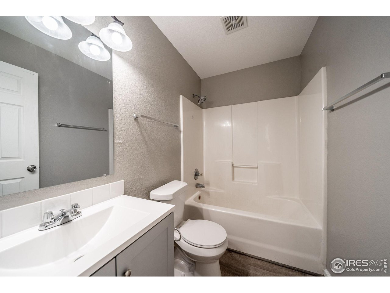 1021 East 25th St Road Greeley, CO 80631 - Photo 15 of 22 a bathroom with a sink toilet vanity and shower