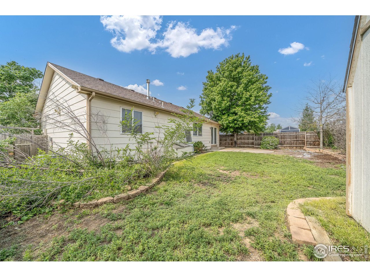 1021 East 25th St Road Greeley, CO 80631 - Photo 21 of 22 a backyard of a house with lots of green space