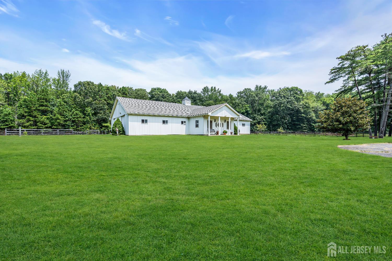 447 Stagecoach Road Millstone Township, NJ 08510 - Photo 12 of 46 a backyard of a house with lots of green space and garden