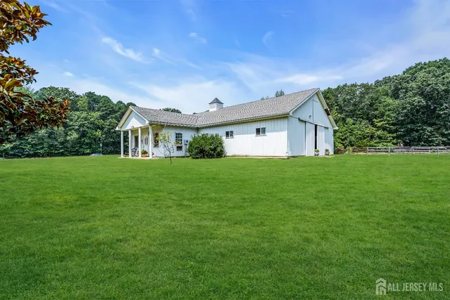 a view of house with a big yard
