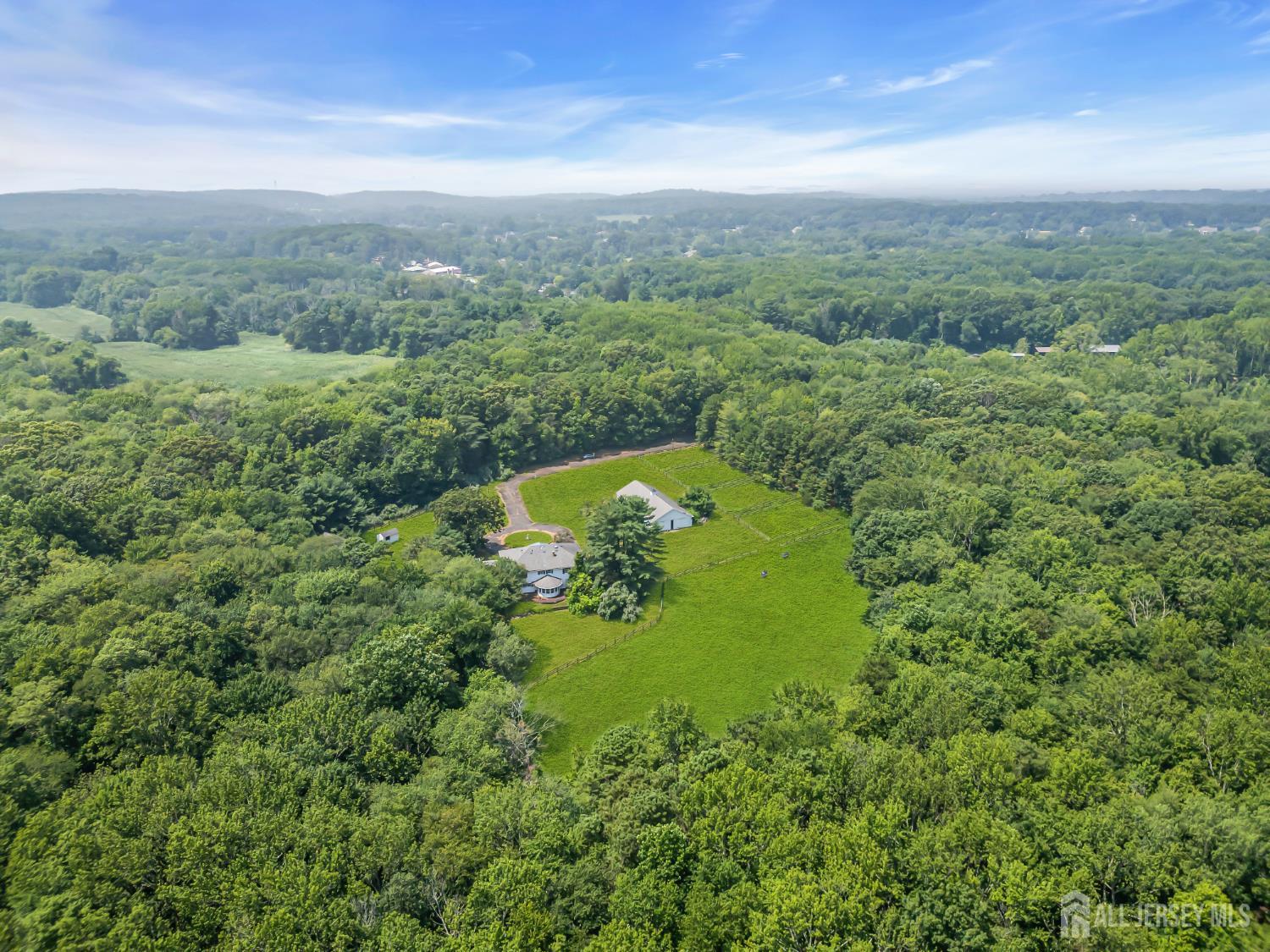 447 Stagecoach Road Millstone Township, NJ 08510 - Photo 37 of 46 a view of a green yard with large trees