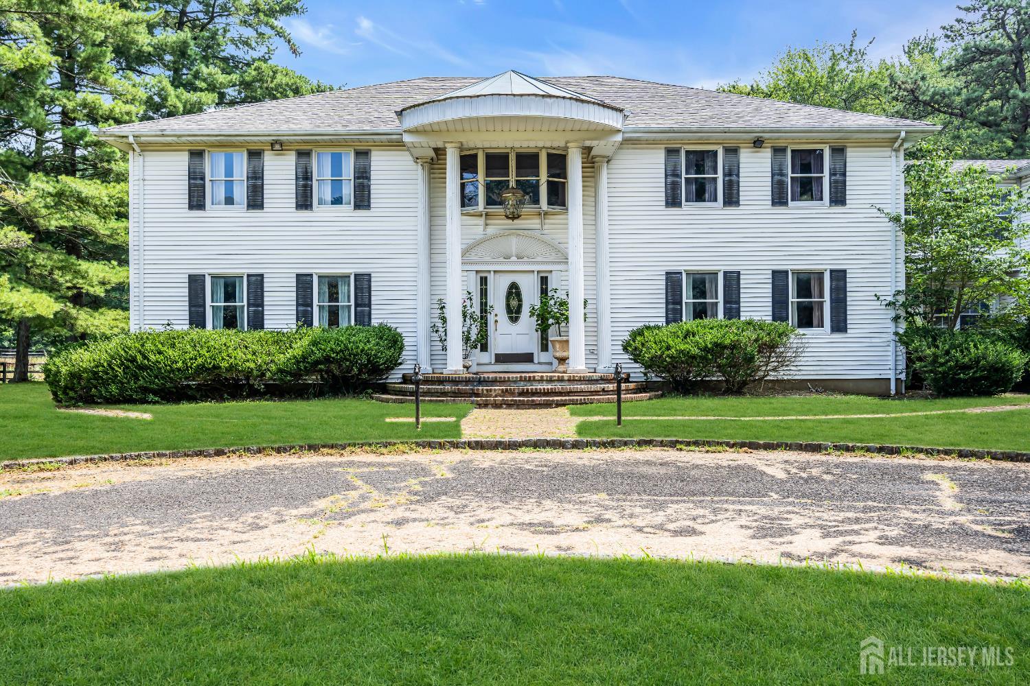447 Stagecoach Road Millstone Township, NJ 08510 - Photo 4 of 46 a front view of a house with a yard and trees