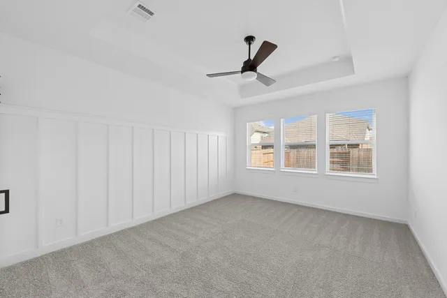 a front view of a house with a yard and potted plants
