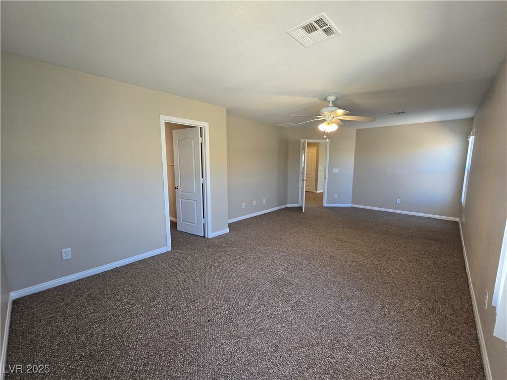 5508 Knotting Pass Las Vegas, NV 89131 - Photo 20 of 45 Unfurnished room with dark carpet and ceiling fan