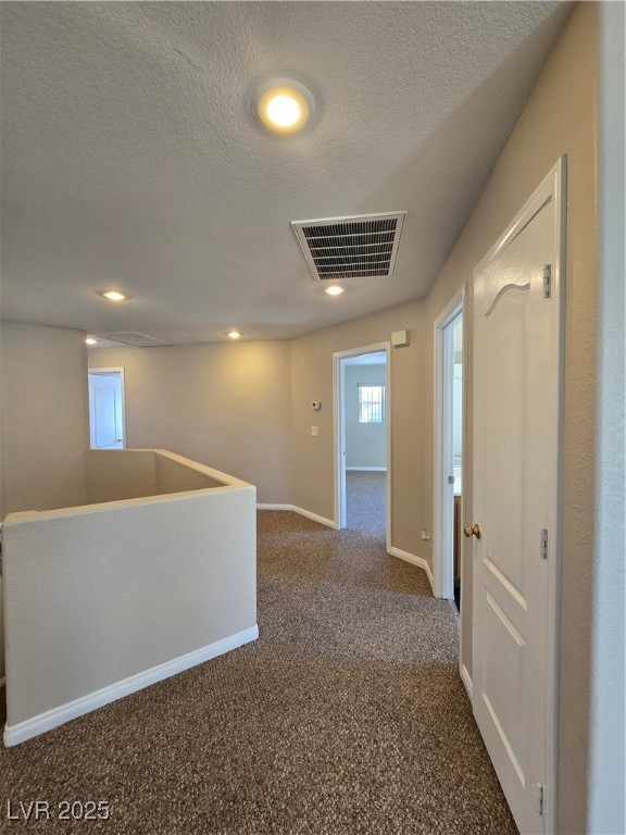 5508 Knotting Pass Las Vegas, NV 89131 - Photo 28 of 45 Hall featuring dark colored carpet, a textured ceiling, recessed lighting, and an upstairs landing
