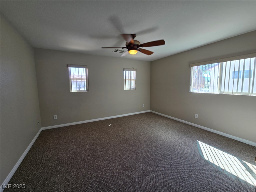 5508 Knotting Pass Las Vegas, NV 89131 - Photo 32 of 45 Empty room featuring dark colored carpet and ceiling fan