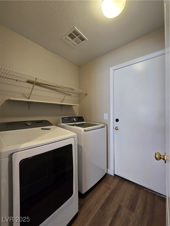 5508 Knotting Pass Las Vegas, NV 89131 - Photo 39 of 45 Washroom with dark wood-type flooring, washing machine and dryer, and a textured ceiling
