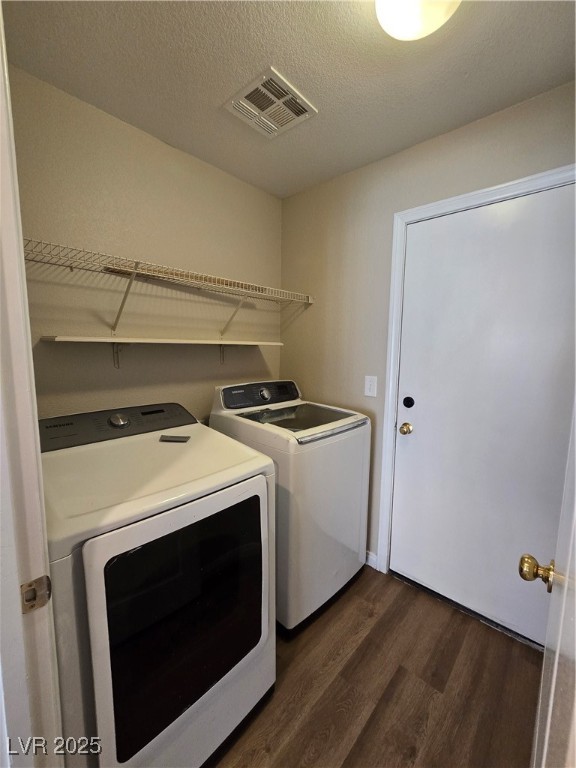 5508 Knotting Pass Las Vegas, NV 89131 - Photo 40 of 45 Washroom featuring dark wood-style floors, a textured ceiling, and independent washer and dryer