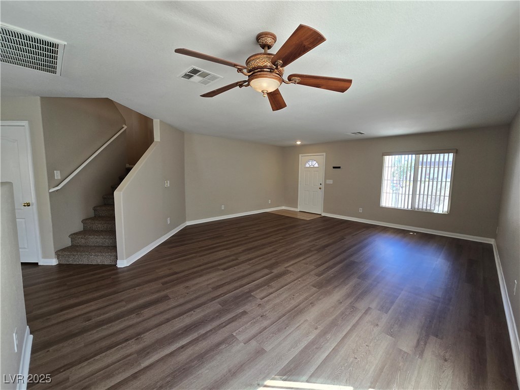 5508 Knotting Pass Las Vegas, NV 89131 - Photo 6 of 45 Unfurnished living room with stairs, dark wood-style flooring, and ceiling fan