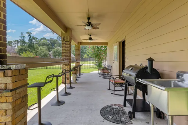 a view of a patio with a table and chairs under an umbrella