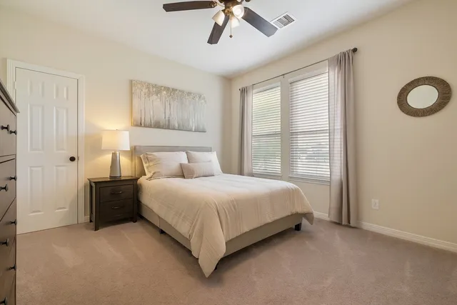 a front view of a house with a yard and trees