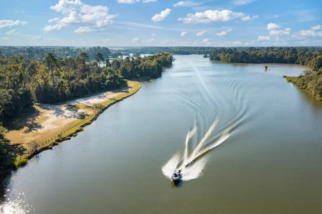 a view of a dining room with furniture a chandelier and wooden floor