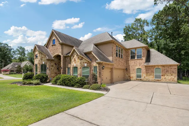a living room with furniture a flat screen tv and a window