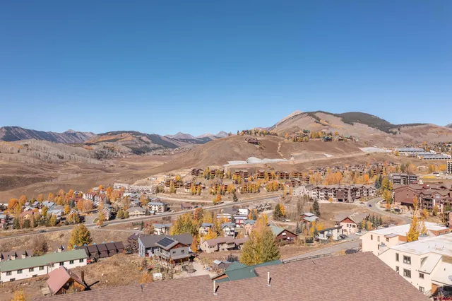 a view of a large building with mountains in the background