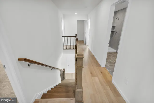 a view of entryway and hall with wooden floor