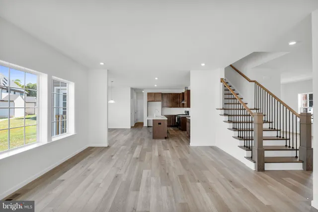 a kitchen with stainless steel appliances a sink a stove a refrigerator and cabinets