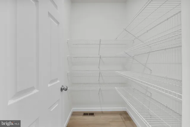 a kitchen with kitchen island granite countertop white cabinets and refrigerator