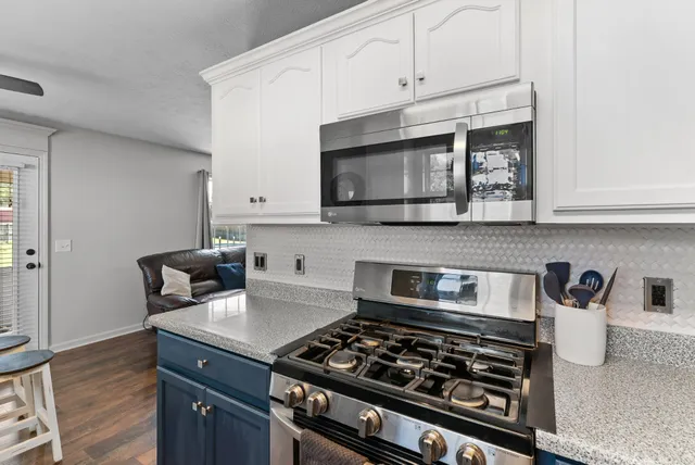 a kitchen with stainless steel appliances granite countertop a sink and a refrigerator