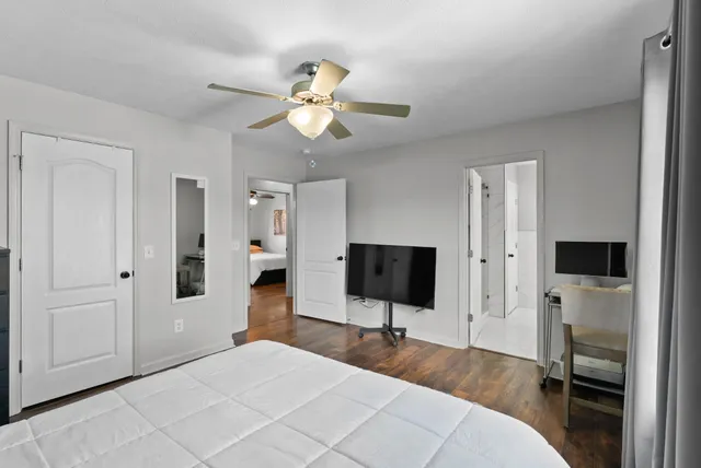 a bedroom with a large bed and a chandelier