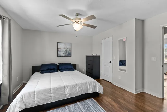 a bathroom with a granite countertop toilet a sink and mirror