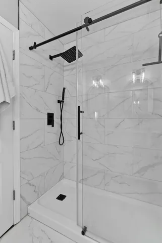 a bedroom with a large bed and a chandelier