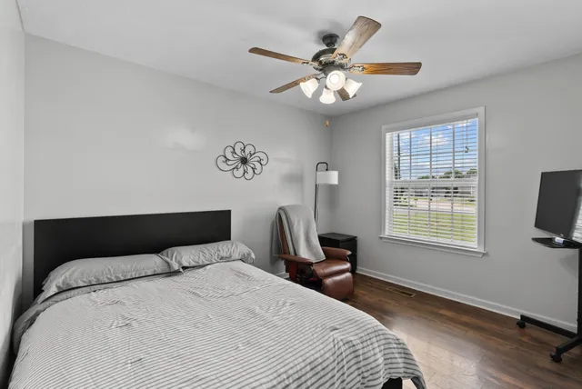 a bedroom with a bed and wooden floor