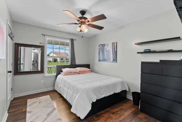 a bedroom with a large bed and a window