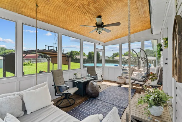 a view of a patio with table and chairs and potted plants