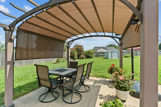 a view of a patio with chairs and a table