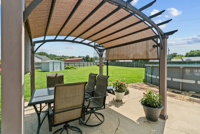 a backyard of a house with table and chairs