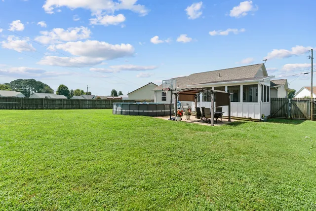 a view of a house with a big yard and large trees